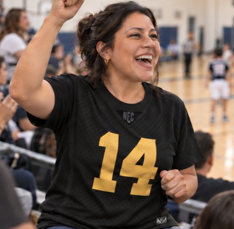 Mom cheering in a black number 14 fan tee at a basketball game
